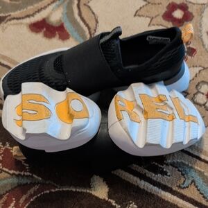 Sorel Women's Black Slip-On Sneakers with Yellow Accent